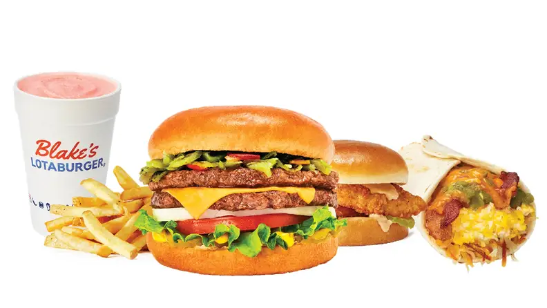 A green chile cheeseburger with fries and a shake, next to a chicken sandwich and burrito