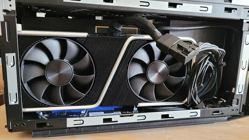 An open desktop PC case showing a graphics card