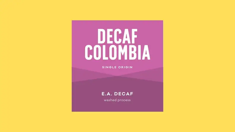 A decaf coffee label against a bright yellow background.