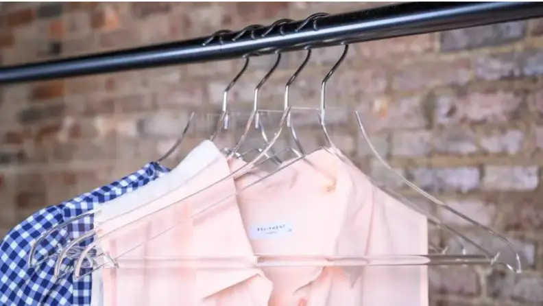 Clothing hanging from clear plastic hangers
