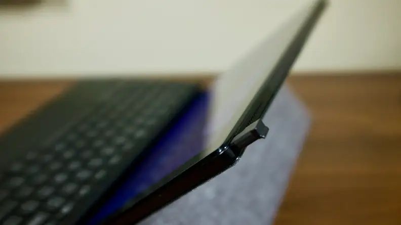 A close-up of the CM3's stylus slot, with the stylus peeking out a bit. There's a slight lip on one end of the stylus to help you pull it out, but it can be tough to grab.