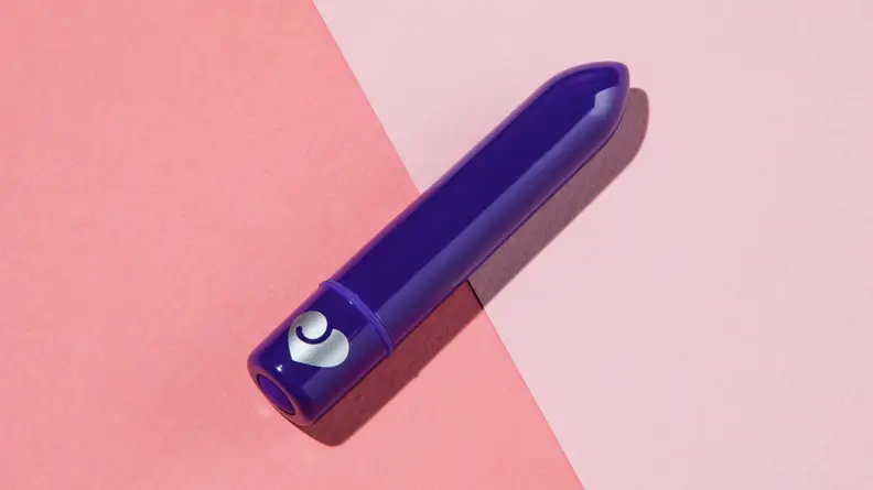 A dark purple Lovehoney Magic Bullet Vibrator on a diagonal angle on top of a two-tone pink background.