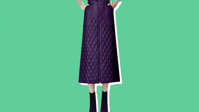 A model wearing a black quilted puffer midi skirt.