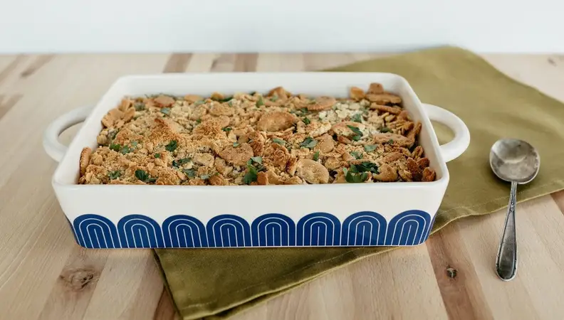 A hot dish on a wooden table with food inside