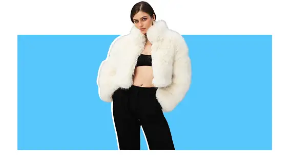 A model wearing a white faux fur jacket.