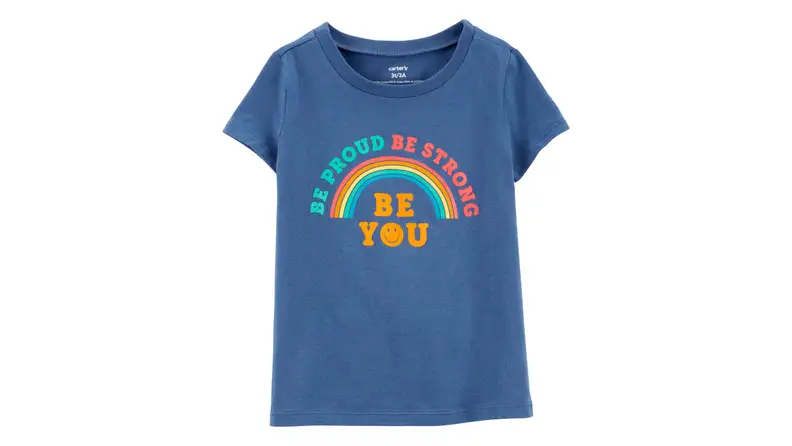 Blue tshirt on a white background with a rainbow across it that says "Be Proud Be Strong Be You"