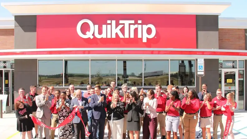QuikTrip company members having a ribbon-cutting outside the store