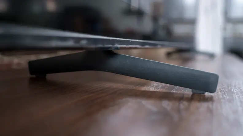 A close side shot of the TV's left stand piece