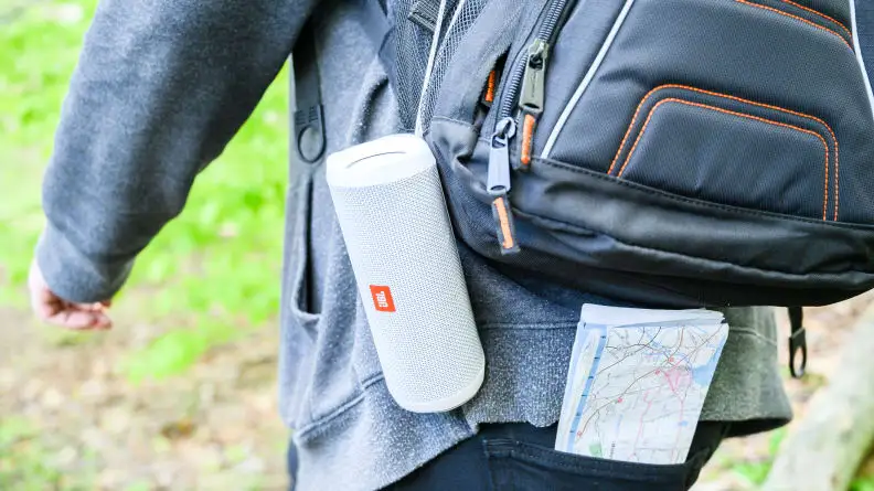 JBL speaker attached to a man with a backpack