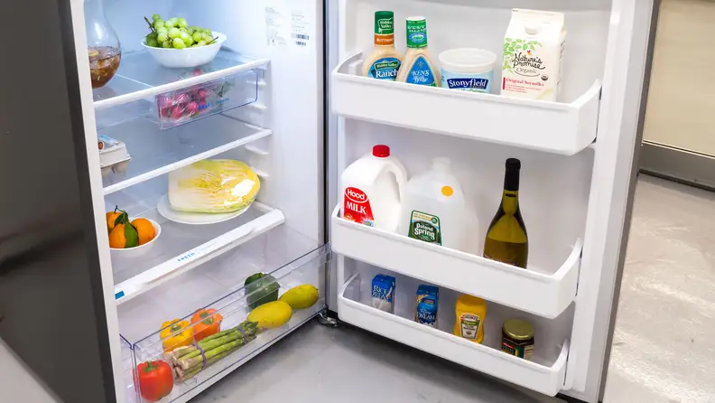 Peering into the main cavity of the Frigidaire FFHT1425VV,which is stocked with groceries.