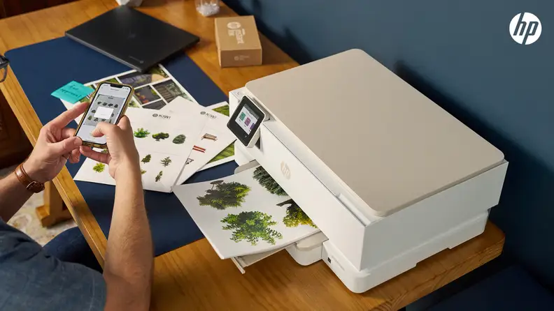 A man prints full-color documents from his phone using an HP printer included in the HP All-In Plan.
