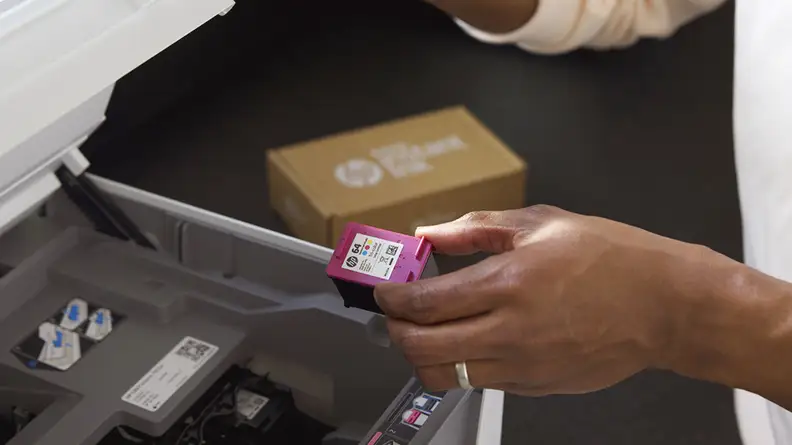 Person holding an ink cartridge