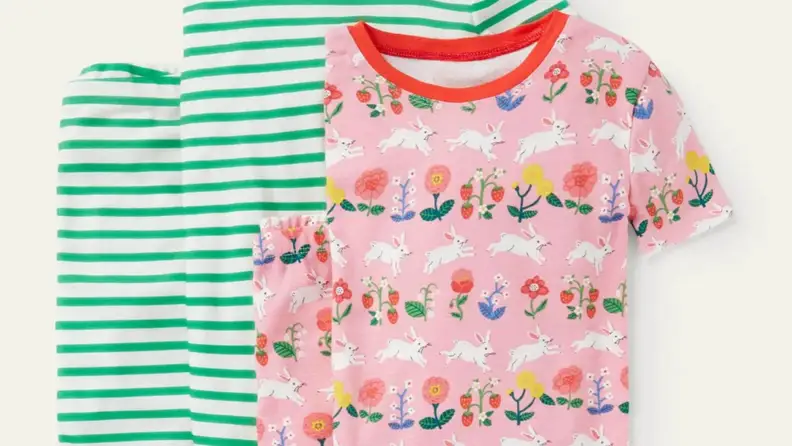 Two sets of pajamas. One in green stripes and one in a pink with an Easter bunny theme.