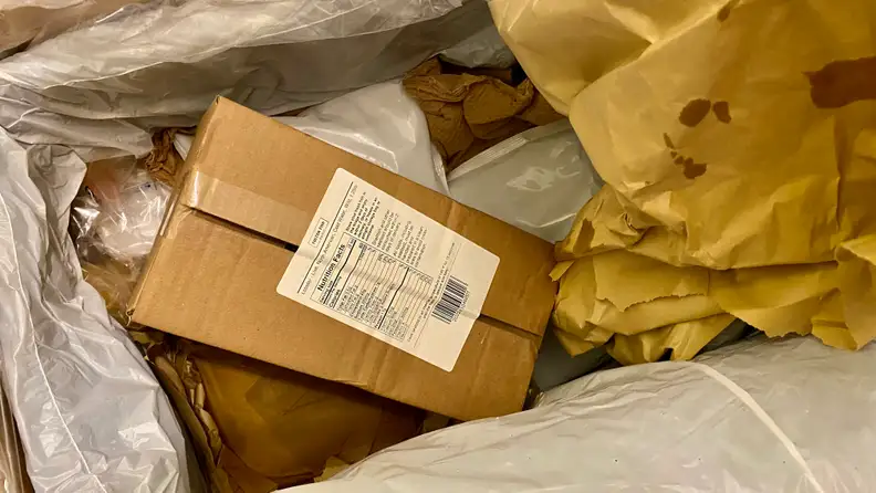 In a padded cardboard box, there's a smaller cardboard box that keeps two lobsters inside.