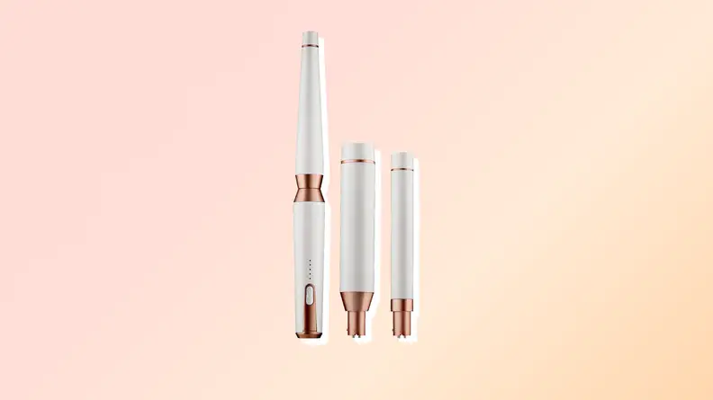 T3 Curling iron against a pink and orange background.