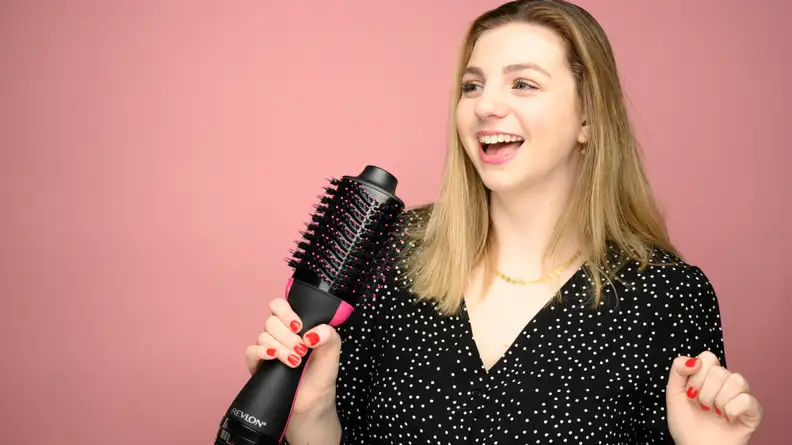 A photo of a woman holding the Revlon One-Step Hair Dryer and Volumizer.