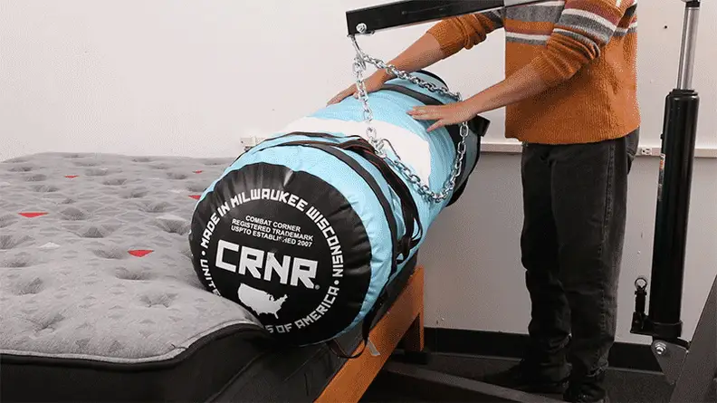 An animated image of a person testing the Zoma Boosts edge support by rolling a boxing bag off the edge.