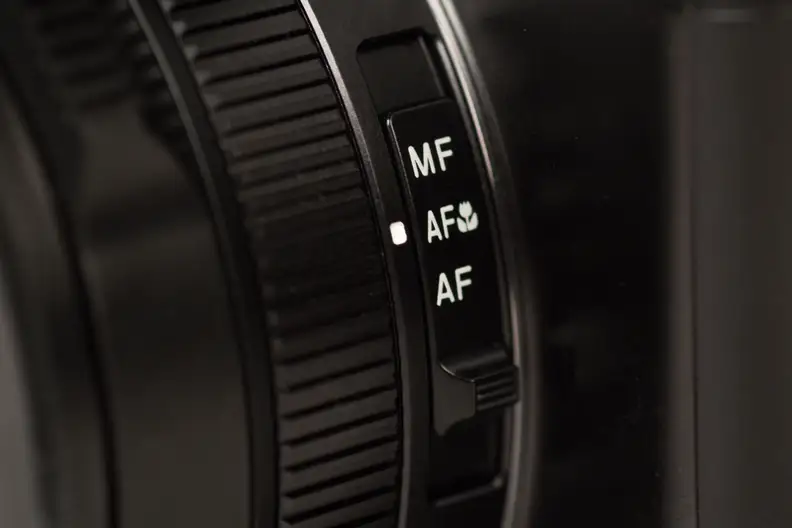 A photograph of the Panasonic Lumix LX100's focus switch.