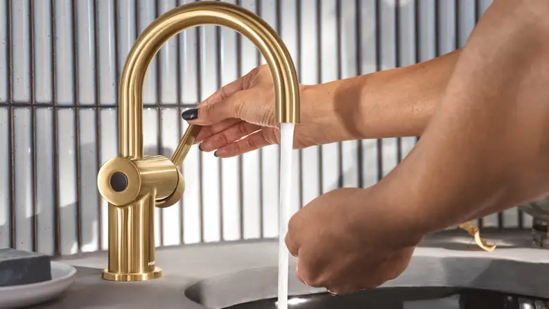 A person washing their hands using the MotionSense Wave Touchless Bathroom Faucet.