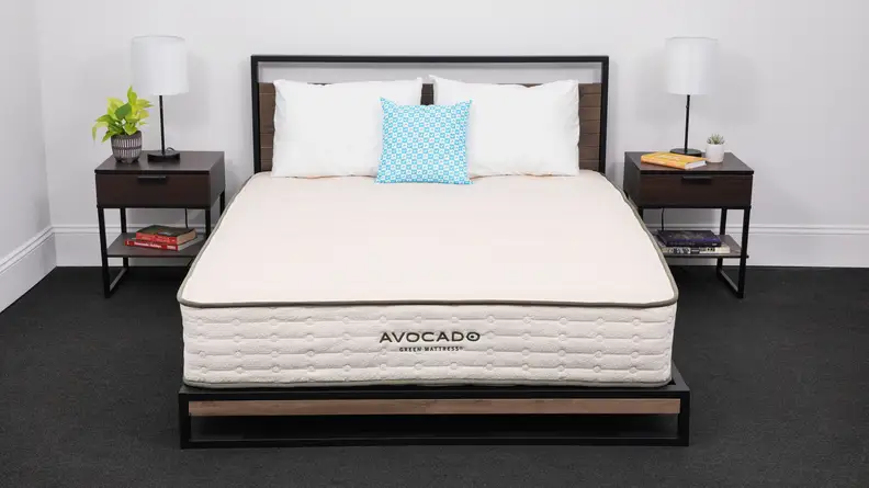 The Avocado Green Mattress between two bedside tables.