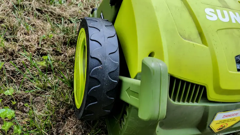 Close-up of a black wheel on a lawn tool