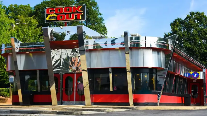 Exterior of a retro-style Cook Out restaurant with a chrome facade