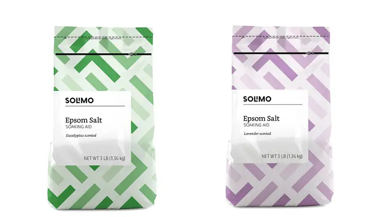 On left, green bag of Solimo epsom salt. On right, purple a bag of epsom Solimo epsom salt.