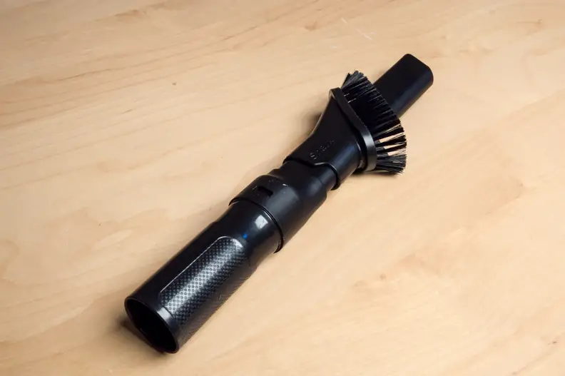 Almost all vacuums come with a crevice-dusting combination wand. The wand can be used to dust shelves and pick up crumbs on couches.