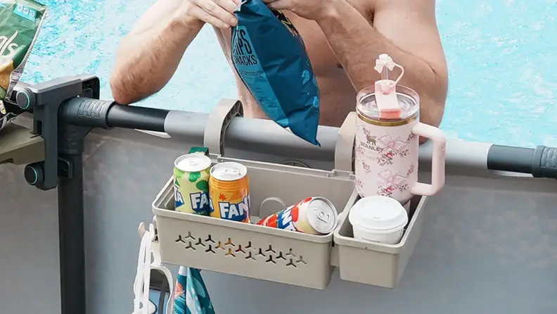 The two-pack of poolside baskets clips onto the pool rail and includes a built-in cup holder