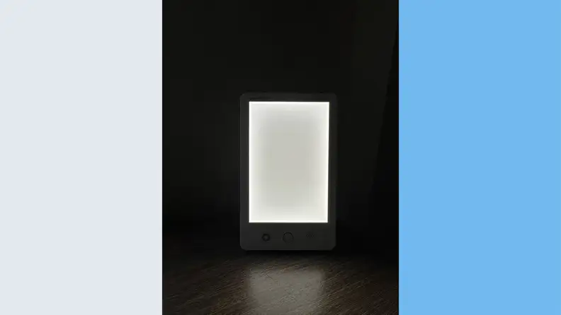The Verilux HappyLight Luex turned on in the darkness with a low color tone
