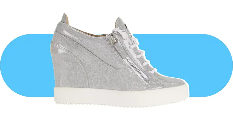 A silver, glitter-covered wedge sneaker.