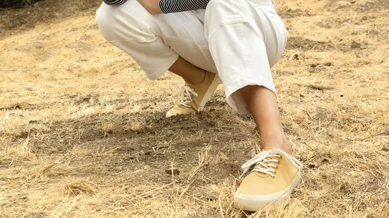 Yellow sneakers in a field.