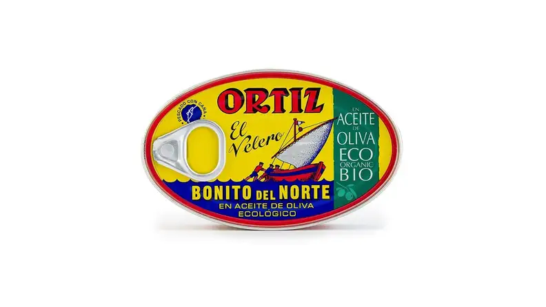 A tin of tuna in olive oil against a white background.