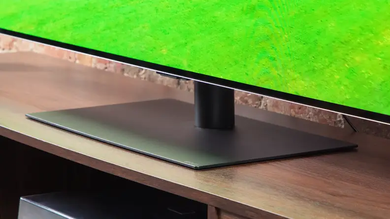 A close-up of the LG G4 OLED TV on a wood entertainment center.