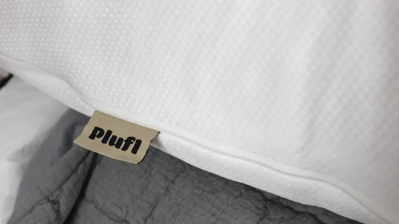 A close-up of the Hugl’s cover, with a tag that reads Plufl.