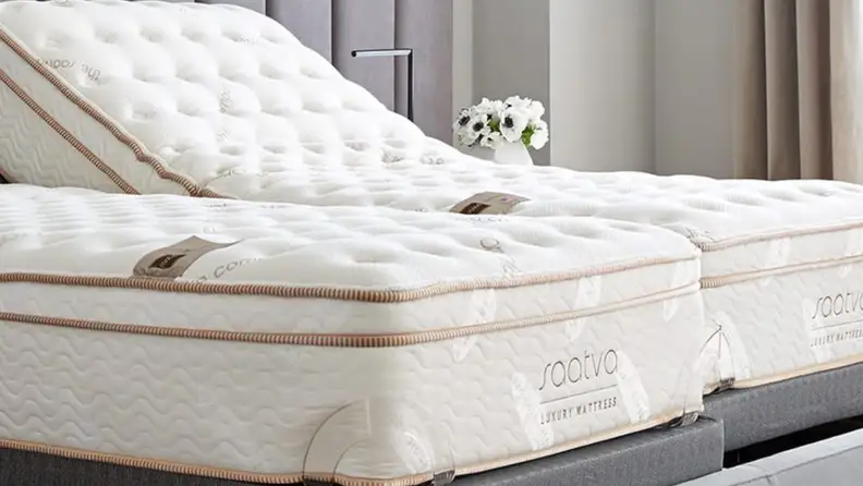 Two Saatva mattresses sitting side by side in bedroom.