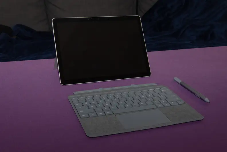 Laptop, keyboard, and stylus lying on the table