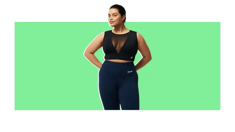 A model wearing a sports bra with a sheer panel.