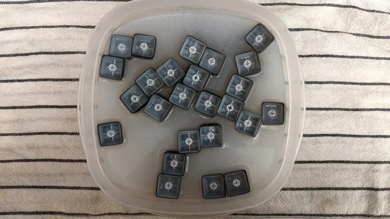 Keycaps floating upside down in soapy water