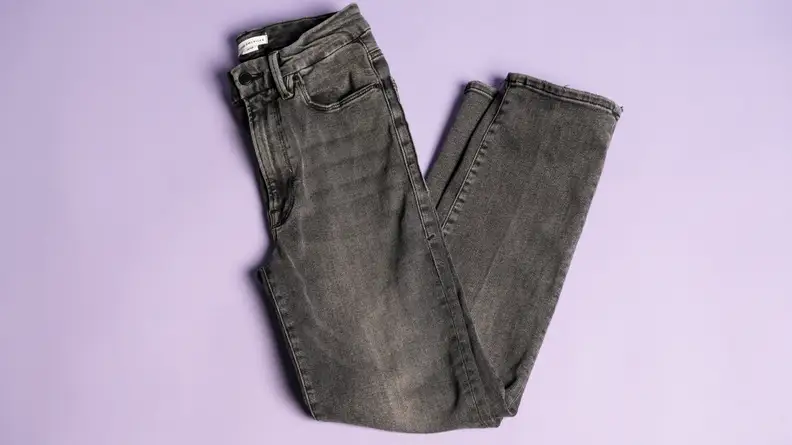 Grey jeans on a lavender background