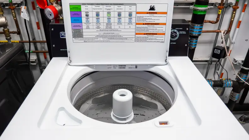 A shot of the Maytag MVWP576KW Top-loading Washing Machine with Pole Agitator in our labs, lid open.