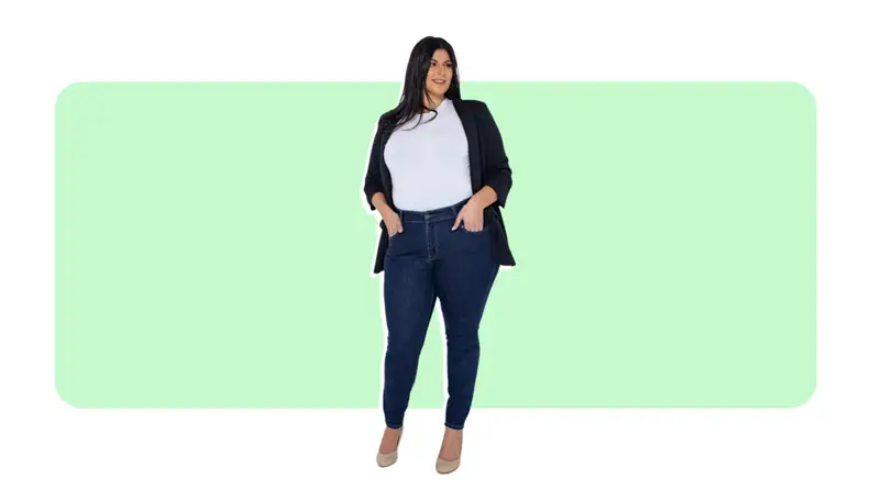 A model wears blue skinny jeans with a white T-Shirt and black cardigan.