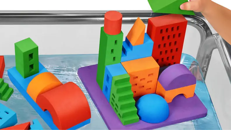 A colorful set of buoyant toy blocks with a city-scape printed on them.