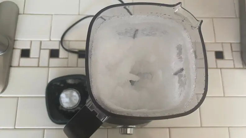 Blended ice and a few chunks inside of Cuisinart Hurricane Compact Juicing Blender.