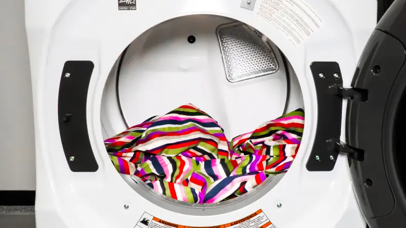 A close-up of the Whirlpool WED6620HW dryer's drum, which has a colorful blanket inside for scale and a pop of color.