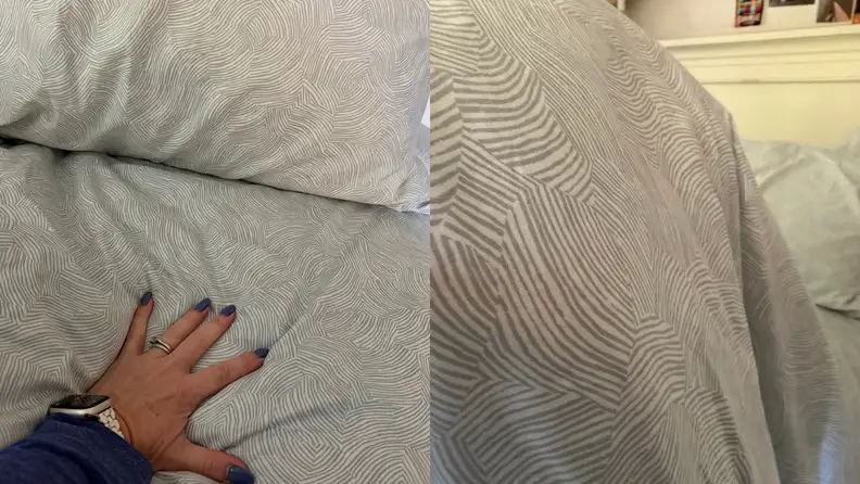 White and grey Brooklinen Luxe Sateen Sheets shown side by side with a woman's hand on top.