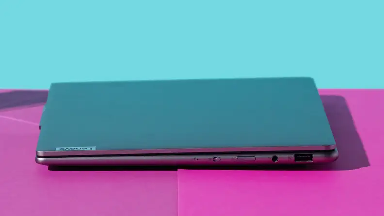 Closed Lenovo Slim 7 laptop on top of purple surface.