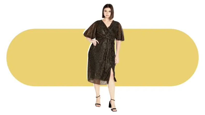 A model wearing a pleated midi dress that has a bronze tone.