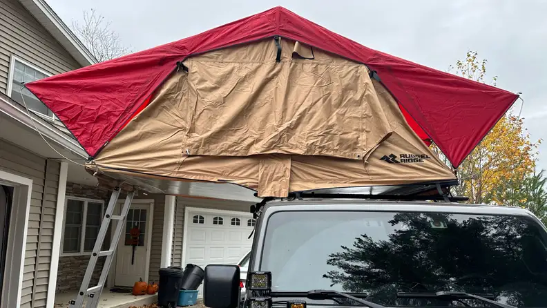 Front view of the Rugged Ridge Roof Top Tent over a gray Jeep Wrangler Rubicon.