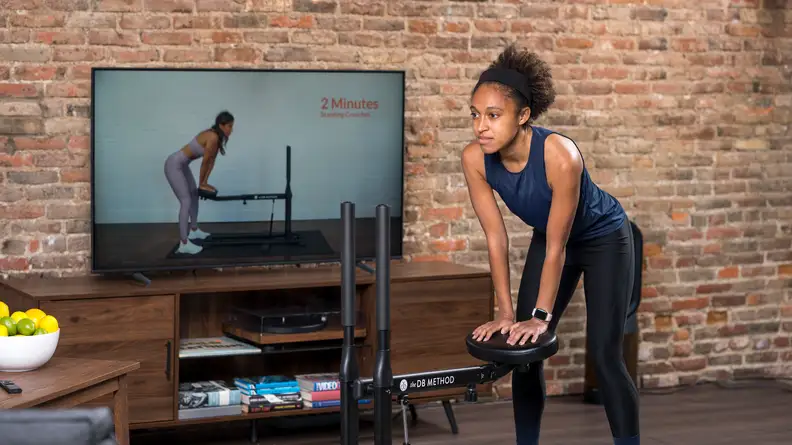 Woman doing Jefferson curls on DB Method machine.